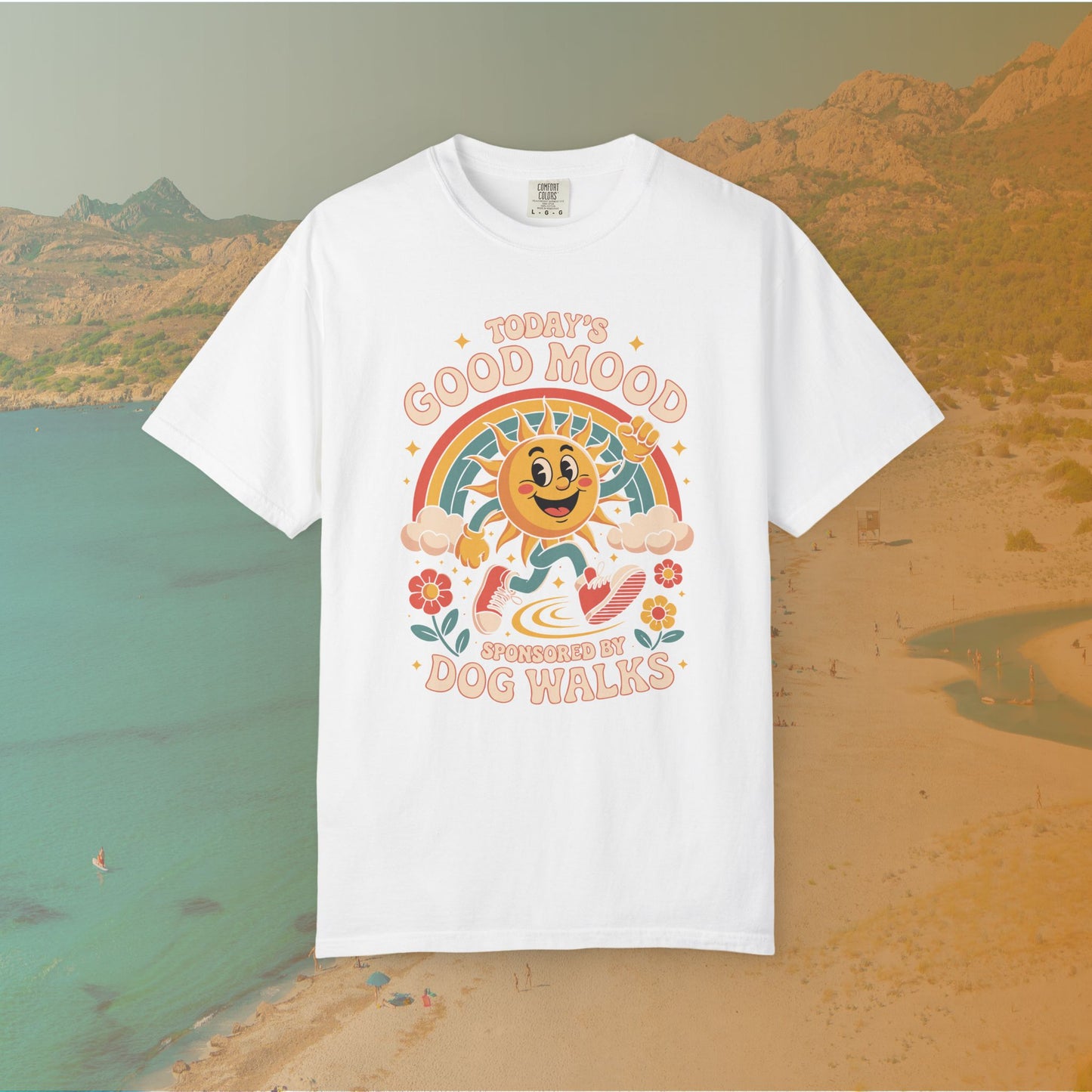 white  t-shirt Retro 70s-style graphic t-shirt featuring a running, happy cartoon sun in sneakers under a rainbow and clouds. The slogan reads: "TODAY'S GOOD MOOD SPONSORED BY DOG WALKS."