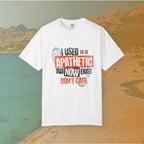 white Graphic T-shirt featuring the layered, distressed text: "I USED TO BE APATHETIC BUT NOW I JUST DON'T CARE," overlaid with halftone dot textures and boot print graphics.