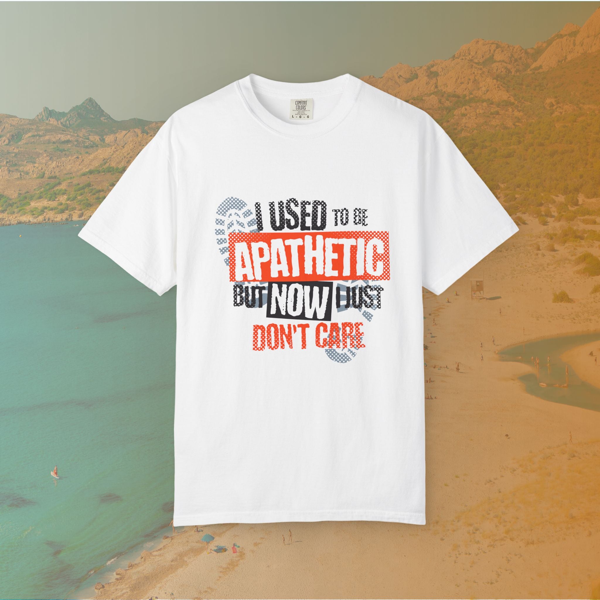 white Graphic T-shirt featuring the layered, distressed text: "I USED TO BE APATHETIC BUT NOW I JUST DON'T CARE," overlaid with halftone dot textures and boot print graphics.
