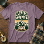 T-shirt with "Raised on Mountain Air & AM Radio" text, mountains, trees, and van graphic.