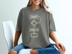 Grey t-shirt with a flowchart: Coast, Too Hot?, No, Yes, Mountain, Problem Solved.
