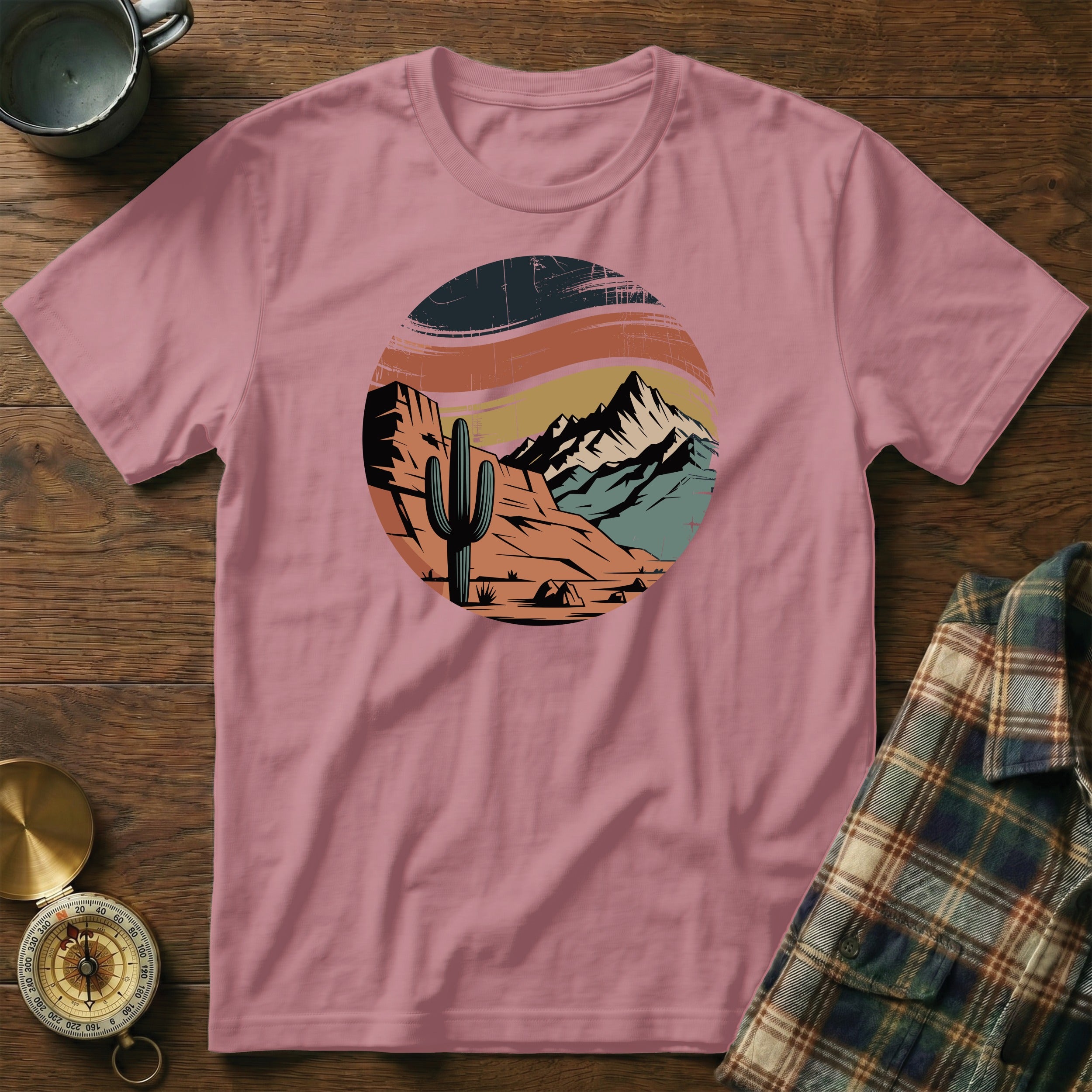 T-shirt with desert mountain landscape graphic and cactus.