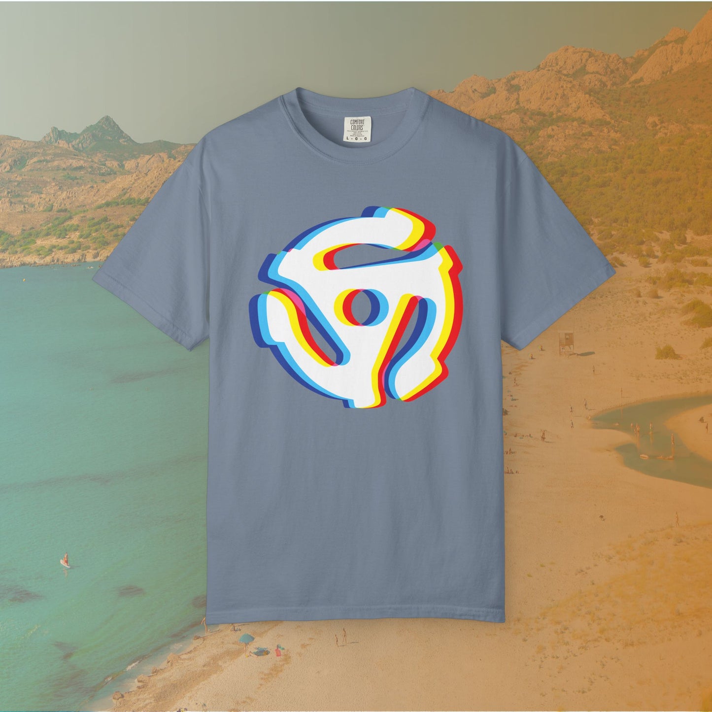 blue t-shirt with a graphic of a white 45 RPM vinyl record adapter (dink) with a red, yellow, blue, and cyan chromatic aberration/glitch effect, ready for EDM festival apparel