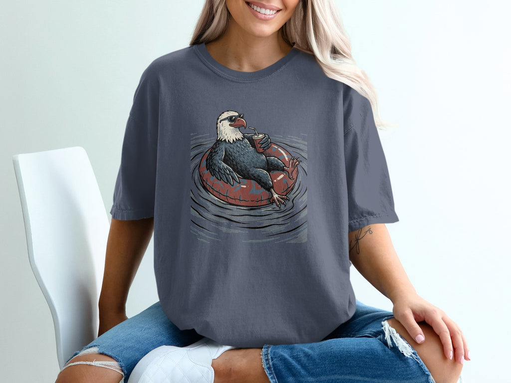 Eagle wearing sunglasses, floating on a tube and drinking a beverage.