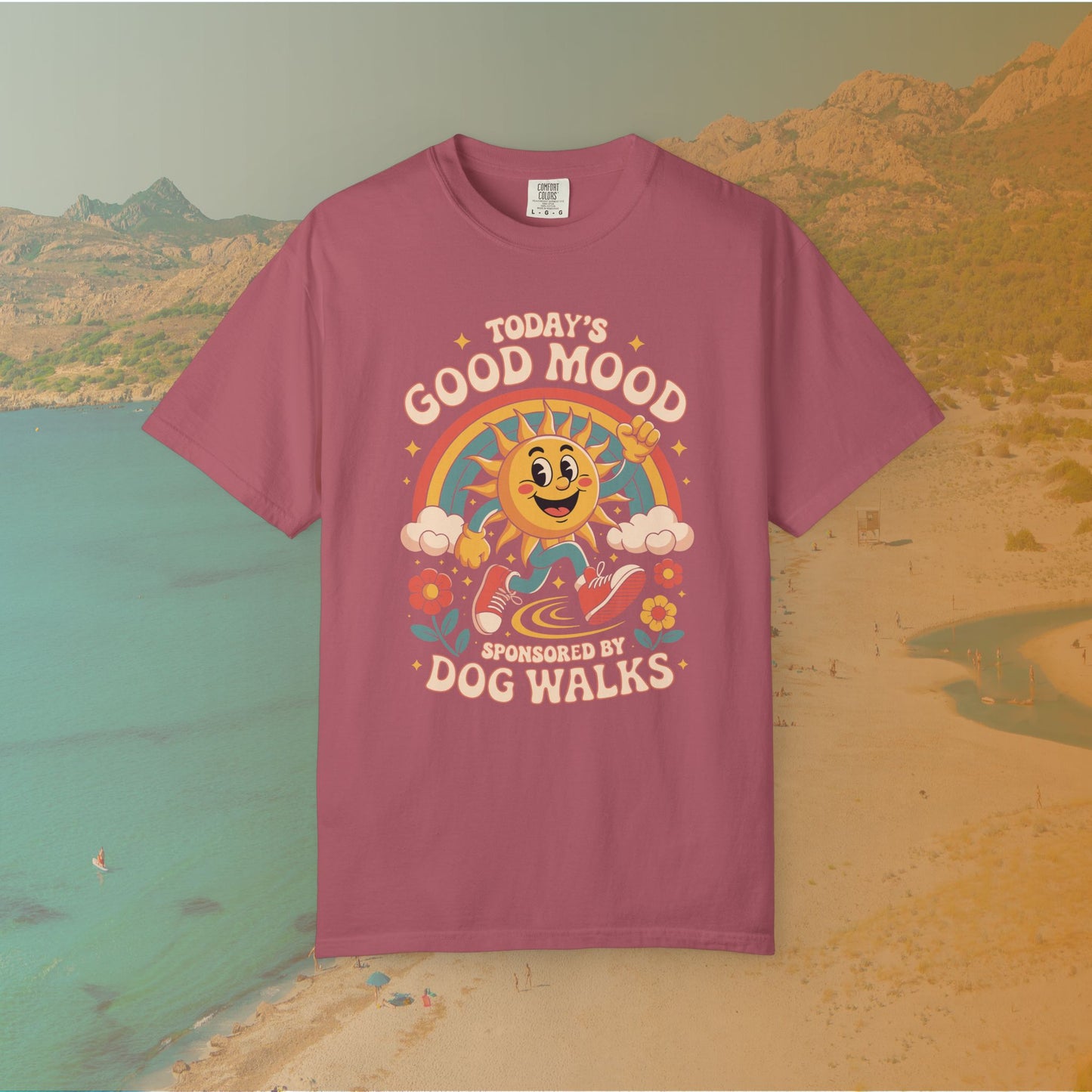 maroon  t-shirt Retro 70s-style graphic t-shirt featuring a running, happy cartoon sun in sneakers under a rainbow and clouds. The slogan reads: "TODAY'S GOOD MOOD SPONSORED BY DOG WALKS."
