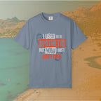 blue Graphic T-shirt featuring the layered, distressed text: "I USED TO BE APATHETIC BUT NOW I JUST DON'T CARE," overlaid with halftone dot textures and boot print graphics.