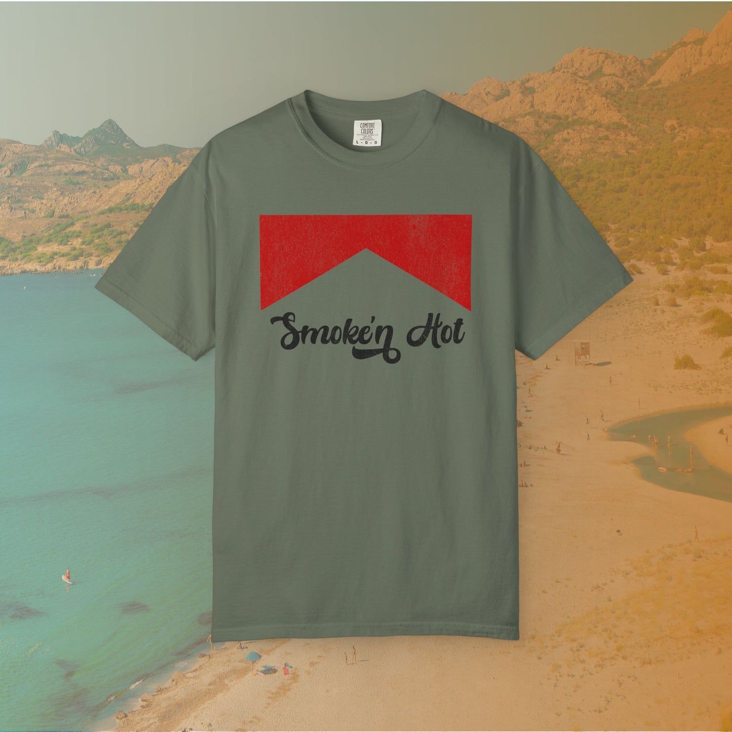 green Graphic T-shirt featuring a distressed red chevron shape with the black script text "Smokin' Hot" centered below it, in a vintage style.