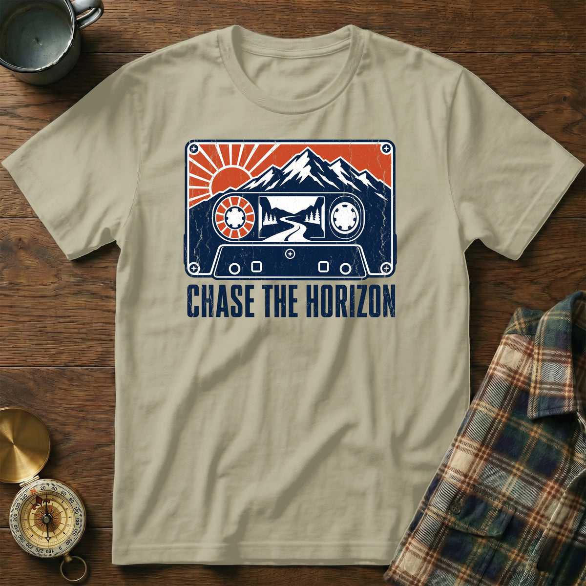 T-shirt with cassette graphic featuring mountains, sun, road, and "CHASE THE HORIZON" text.