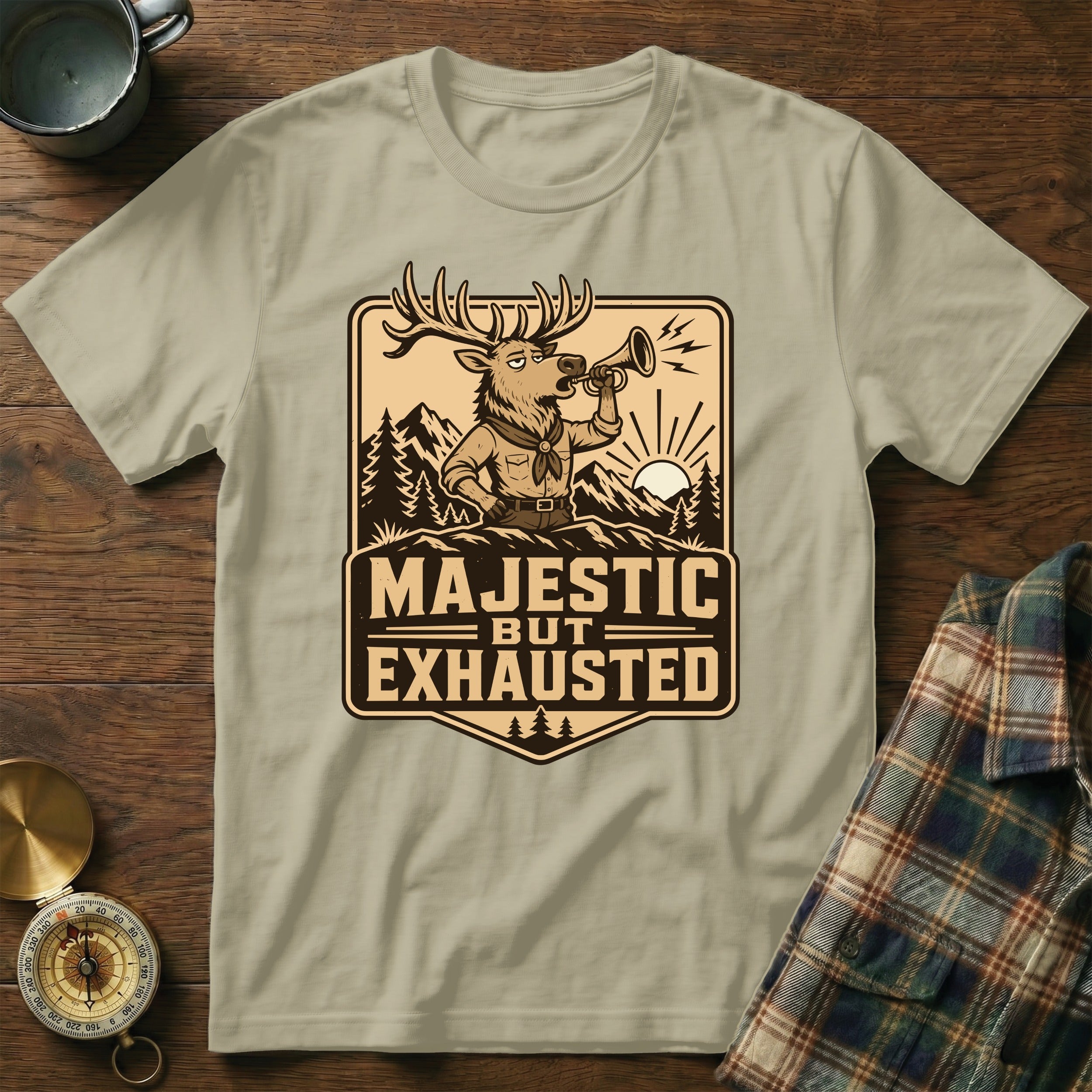 T-shirt with a cartoon deer blowing a horn, text "MAJESTIC BUT EXHAUSTED".