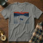 Grey t-shirt with a graphic of a canoe on a lake at sunset.