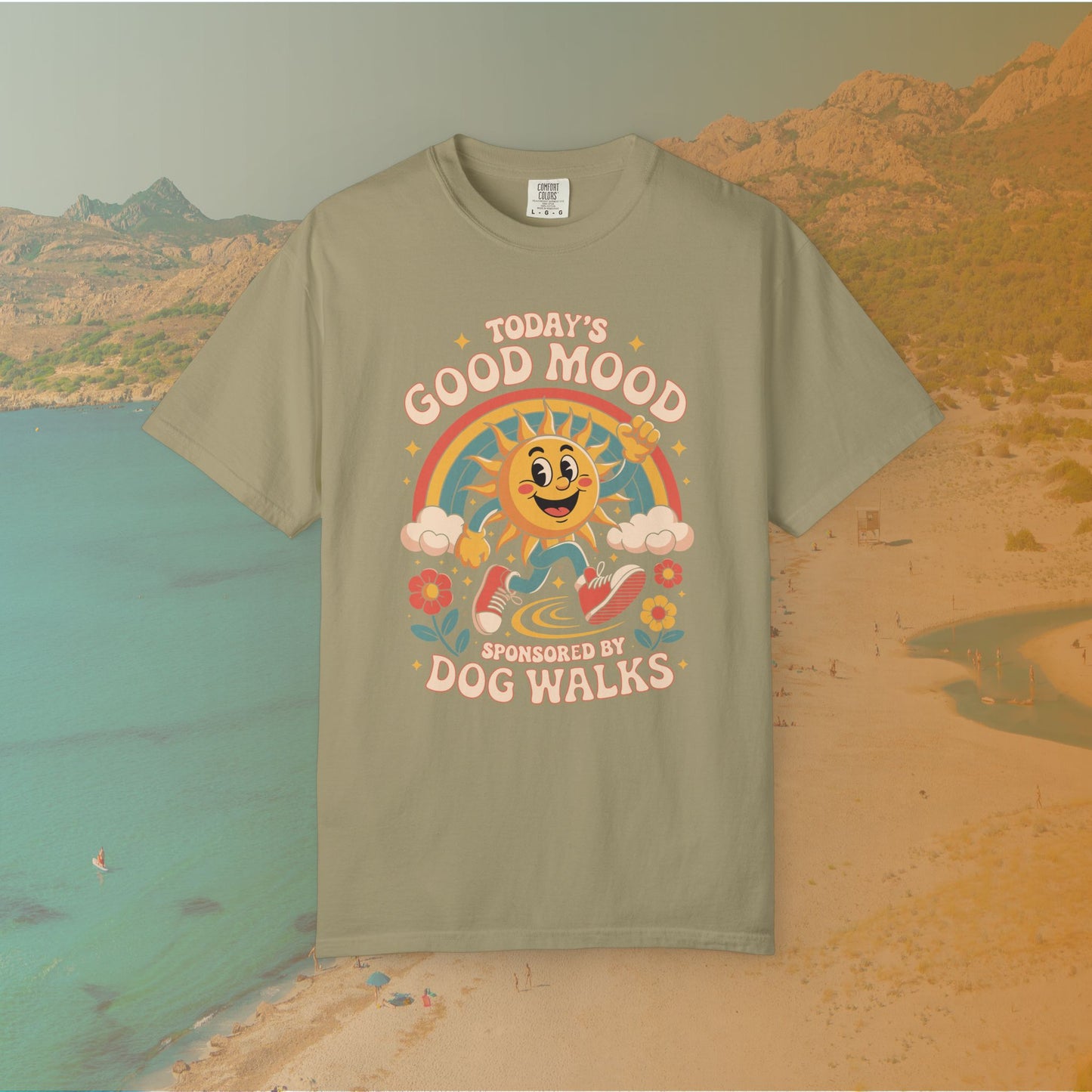 green  t-shirt Retro 70s-style graphic t-shirt featuring a running, happy cartoon sun in sneakers under a rainbow and clouds. The slogan reads: "TODAY'S GOOD MOOD SPONSORED BY DOG WALKS."
