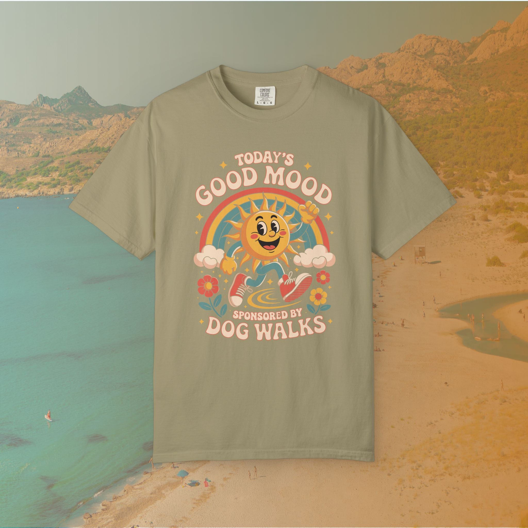 green  t-shirt Retro 70s-style graphic t-shirt featuring a running, happy cartoon sun in sneakers under a rainbow and clouds. The slogan reads: "TODAY'S GOOD MOOD SPONSORED BY DOG WALKS."