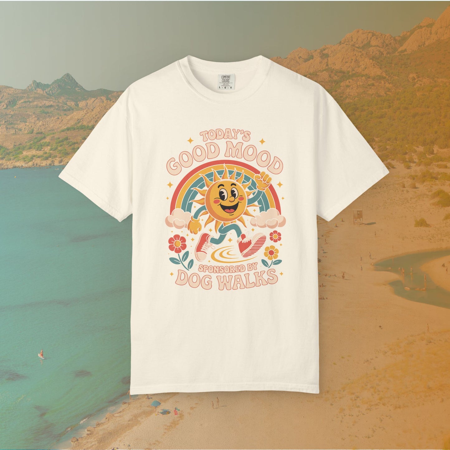 ivory  t-shirt Retro 70s-style graphic t-shirt featuring a running, happy cartoon sun in sneakers under a rainbow and clouds. The slogan reads: "TODAY'S GOOD MOOD SPONSORED BY DOG WALKS."
