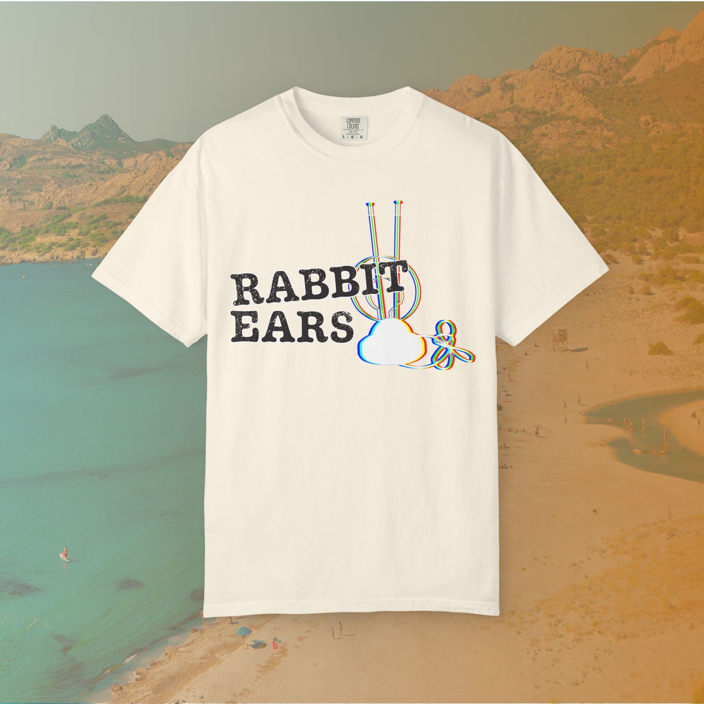 ivory t-shirt distressed EDM music festival text "RABBIT EARS" next to a graphic of a vintage TV antenna and cloud shape with a red, green, and blue (RGB) chromatic aberration/glitch effect, with an RGB shift design