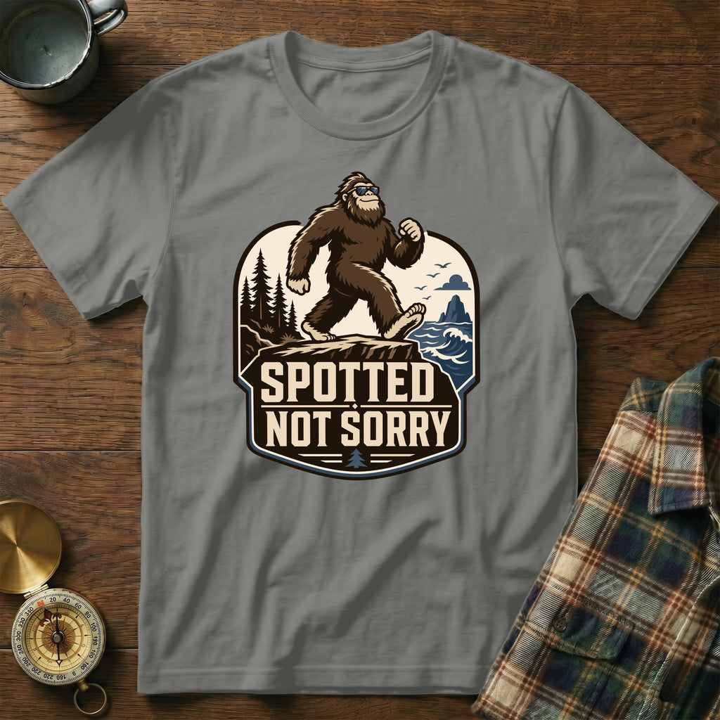 Bigfoot wearing sunglasses walking on a cliff with text "Spotted Not Sorry".
