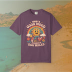 purple  t-shirt Retro 70s-style graphic t-shirt featuring a running, happy cartoon sun in sneakers under a rainbow and clouds. The slogan reads: "TODAY'S GOOD MOOD SPONSORED BY DOG WALKS."