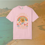 pink  t-shirt Retro 70s-style graphic t-shirt featuring a running, happy cartoon sun in sneakers under a rainbow and clouds. The slogan reads: "TODAY'S GOOD MOOD SPONSORED BY DOG WALKS."