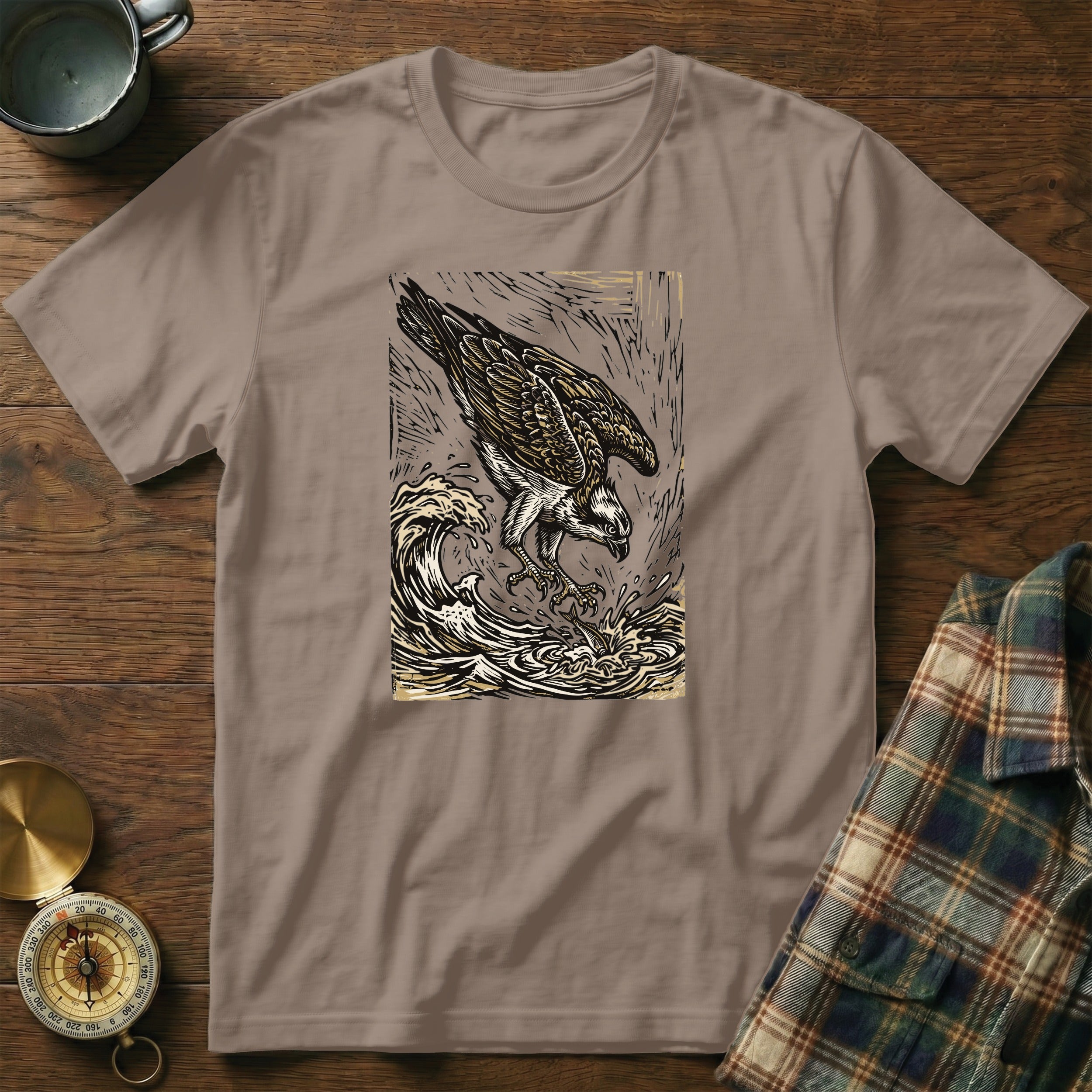 T-shirt with graphic of an osprey diving into waves.