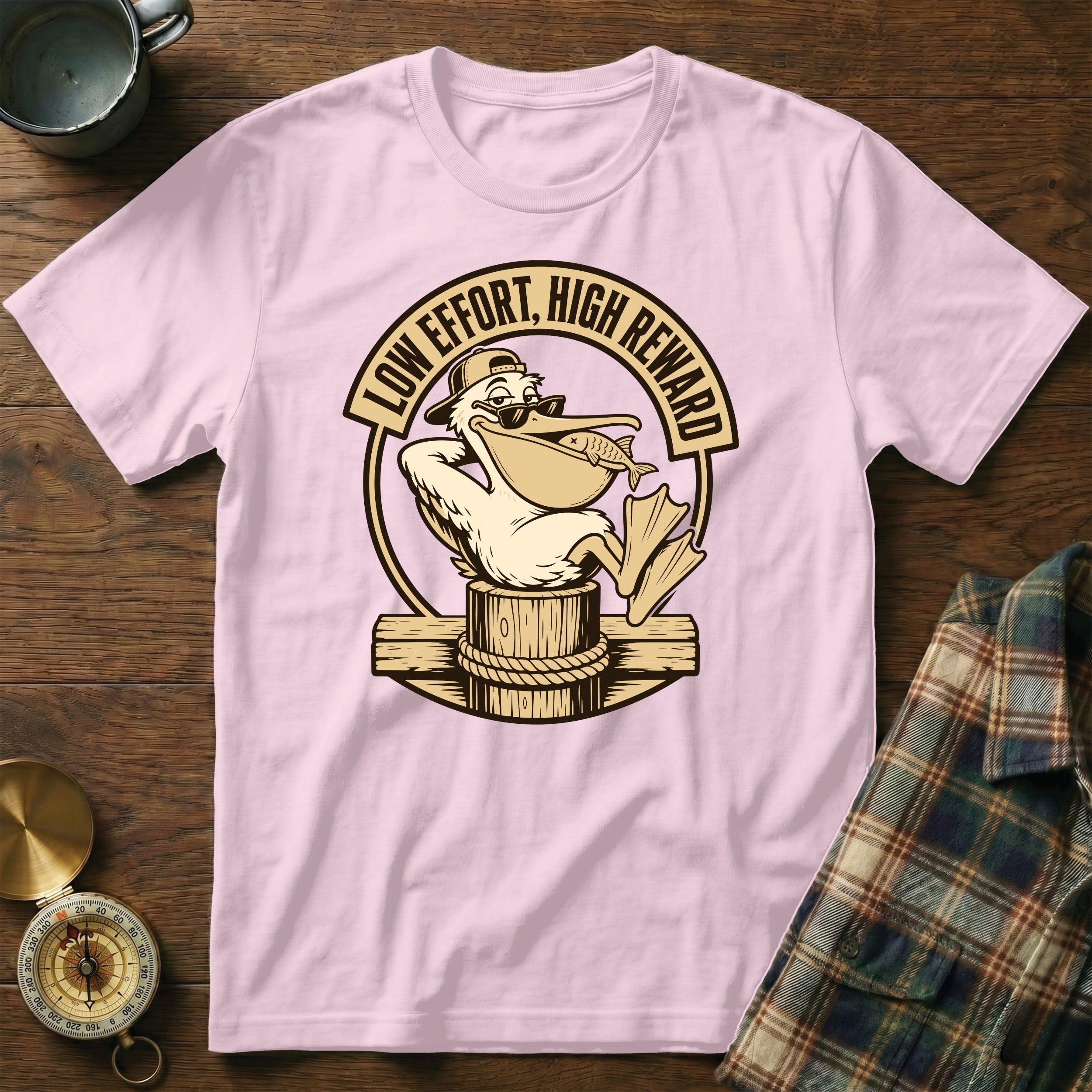 Pink t-shirt with cartoon pelican holding a fish and text "LOW EFFORT, HIGH REWARD".