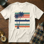 T-shirt with palm trees and sailboat on striped background.