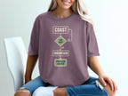 T-shirt with flowchart: Coast, Too Hot? Yes, Mountain, Problem Solved.
