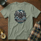Green t-shirt with Kraken octopus design, waves, mountains, and text.