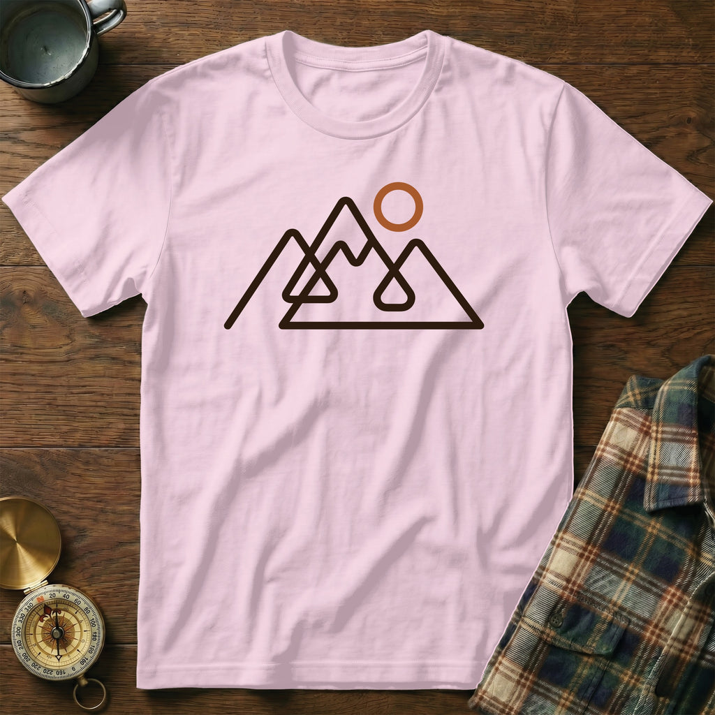 Pink t-shirt with a minimalist mountain range and sun graphic design.