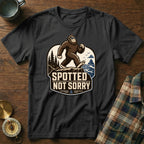 Black t-shirt with a Bigfoot graphic and "Spotted Not Sorry" text.