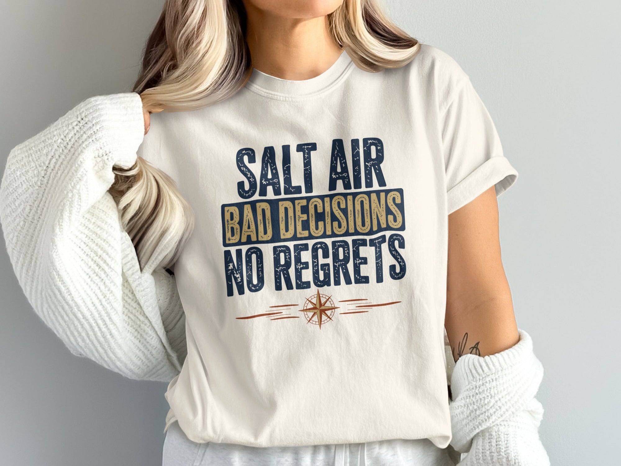 Cream t-shirt with "Salt Air Bad Decisions No Regrets" text and compass graphic.