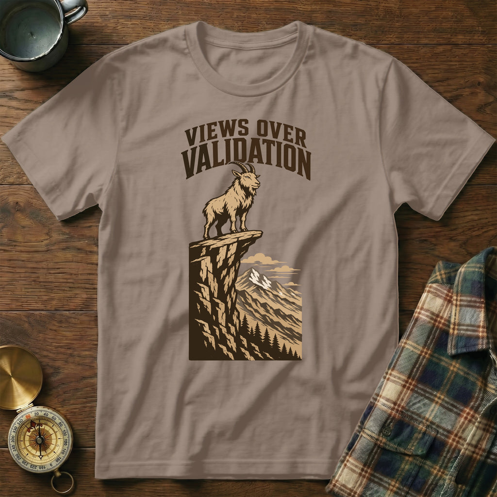 Brown t-shirt with a goat standing on a cliff. Text reads "VIEWS OVER VALIDATION."
