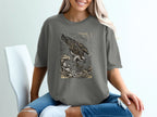 Graphic t-shirt with an osprey diving into stylized waves.