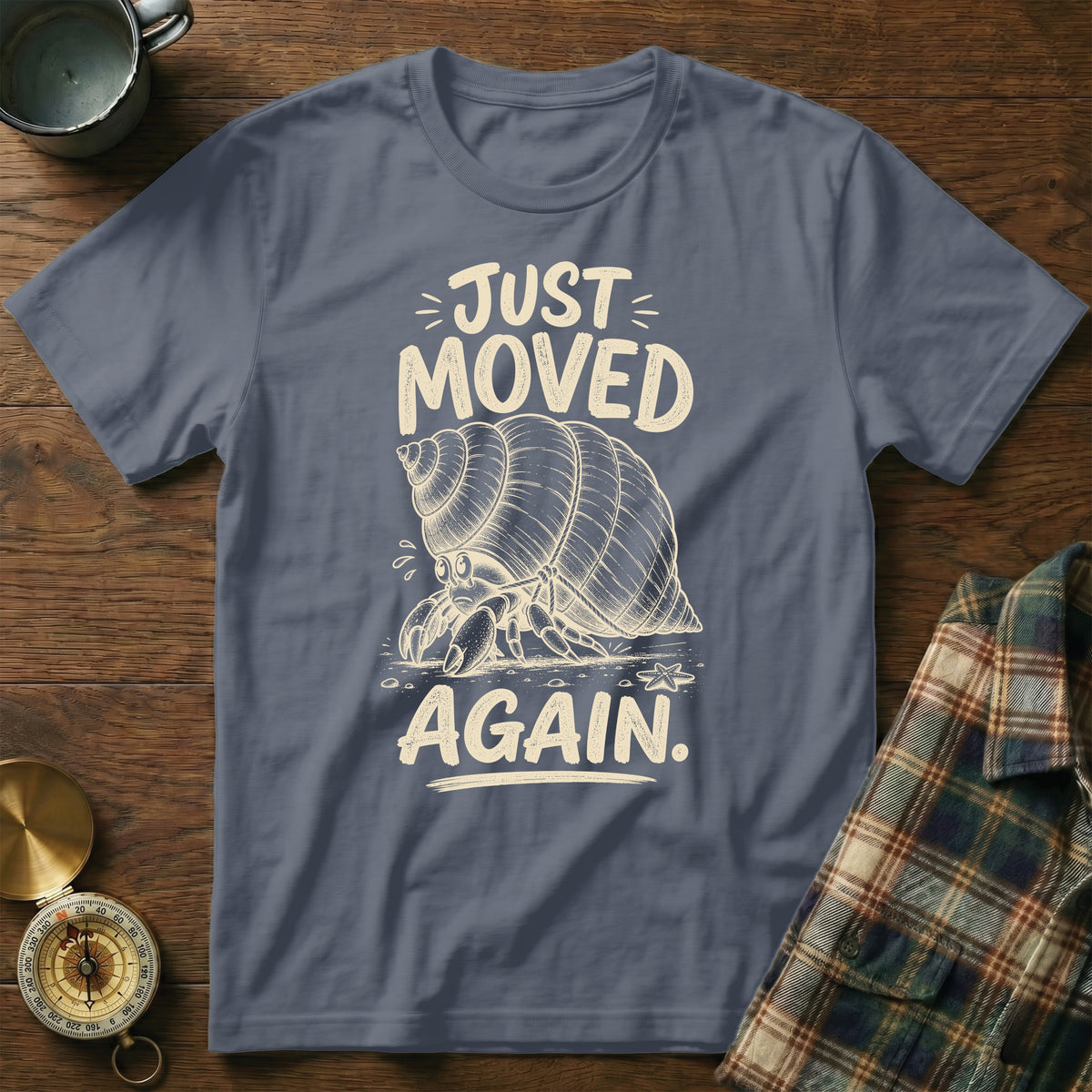 T-shirt with a hermit crab graphic and text "JUST MOVED AGAIN."