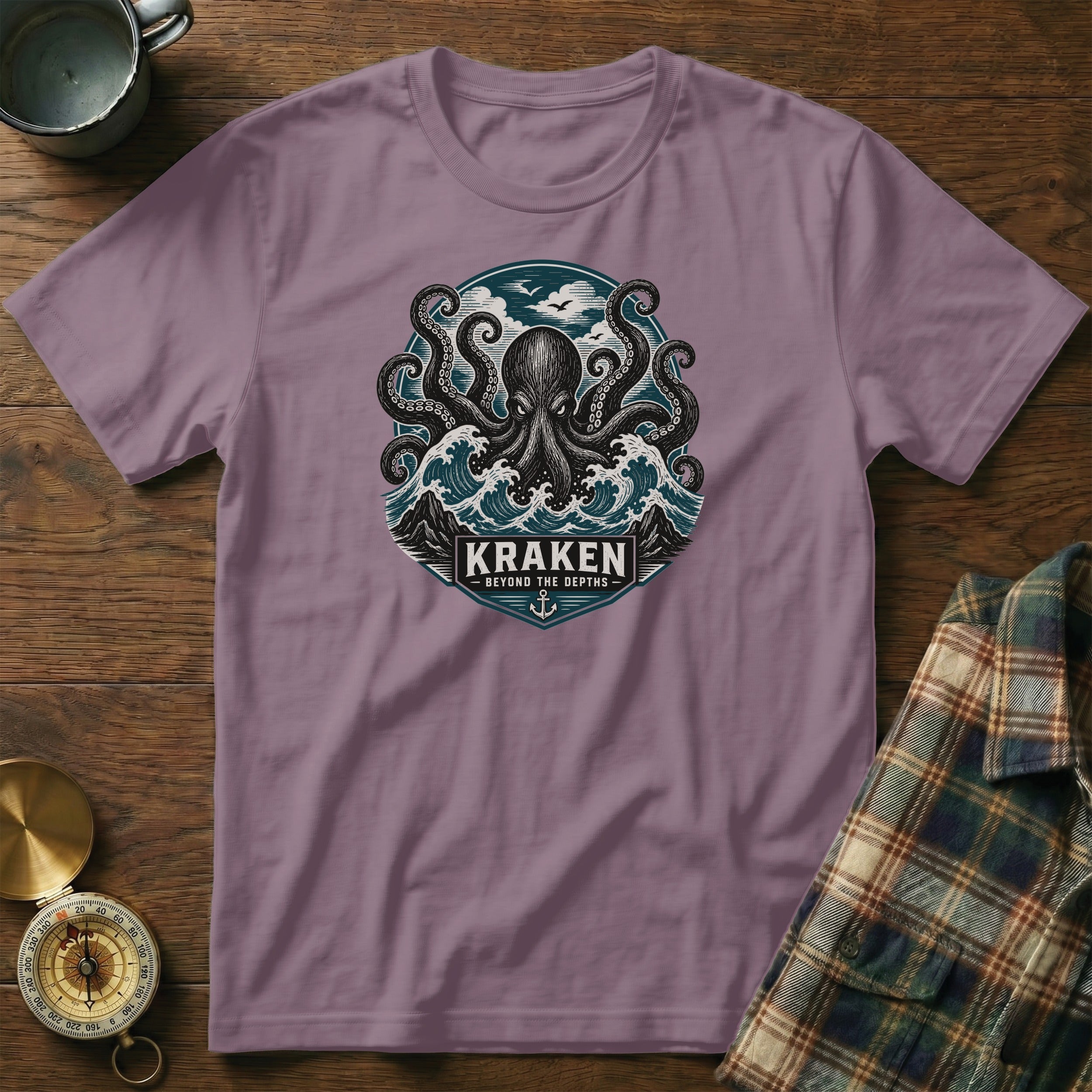 Purple t-shirt with kraken and waves graphic, text "KRAKEN BEYOND THE DEPTHS".