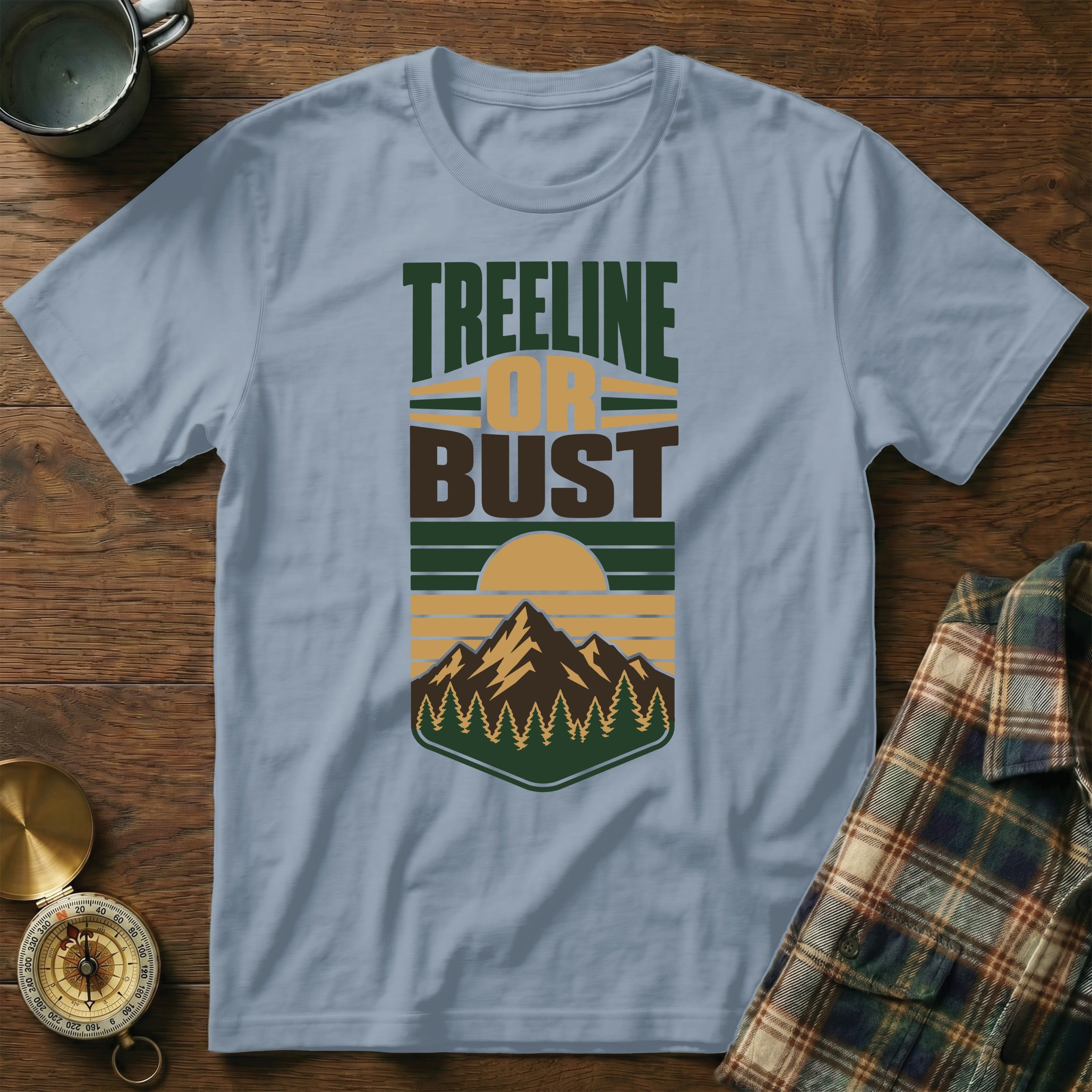 Light blue shirt with "Treeline or Bust" text and mountain graphic.