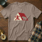 Running figure and bear silhouette within a red and white triangle graphic on a tan t-shirt.