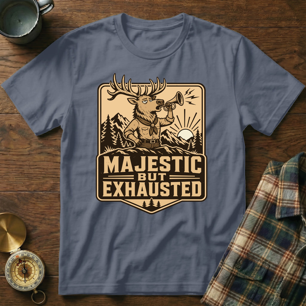 Deer blowing bugle with "Majestic But Exhausted" text, mountains, and sunrise on shirt.