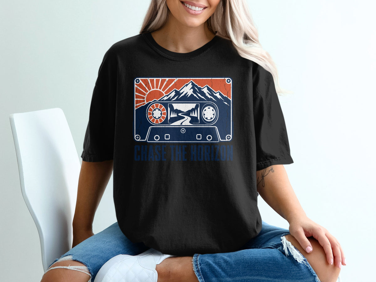 Black t-shirt with cassette tape design featuring mountains, sun, and the text "Chase the Horizon."