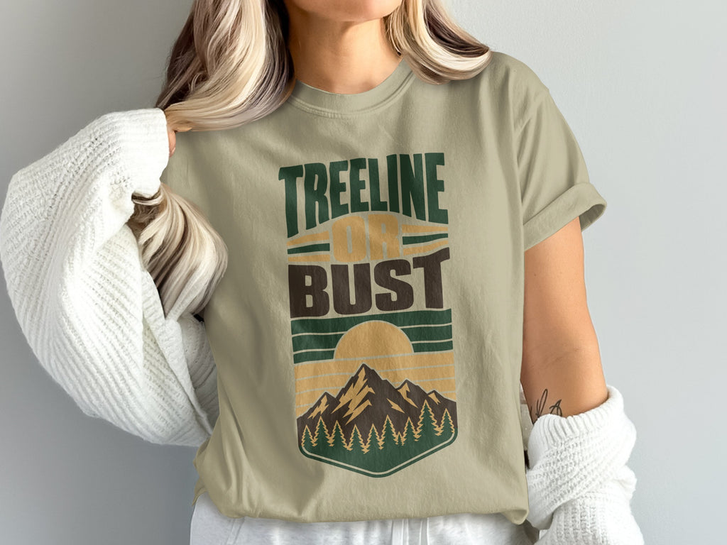 T-shirt with "Treeline or Bust" text and mountain and sun graphic.