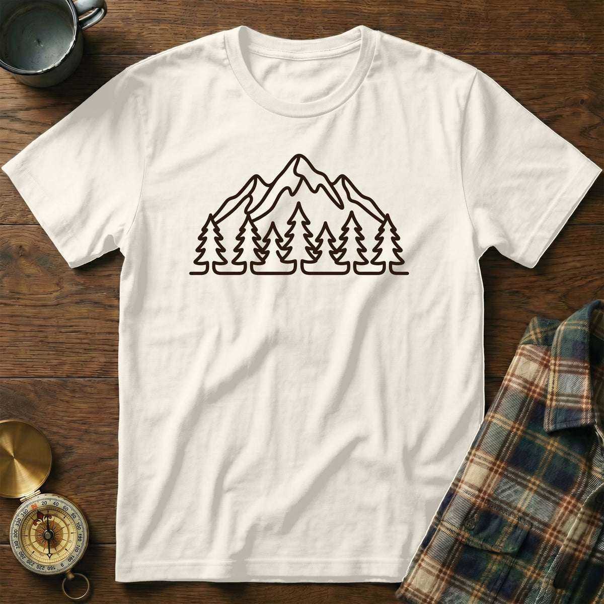 Cream t-shirt with outline of mountains and trees on chest.