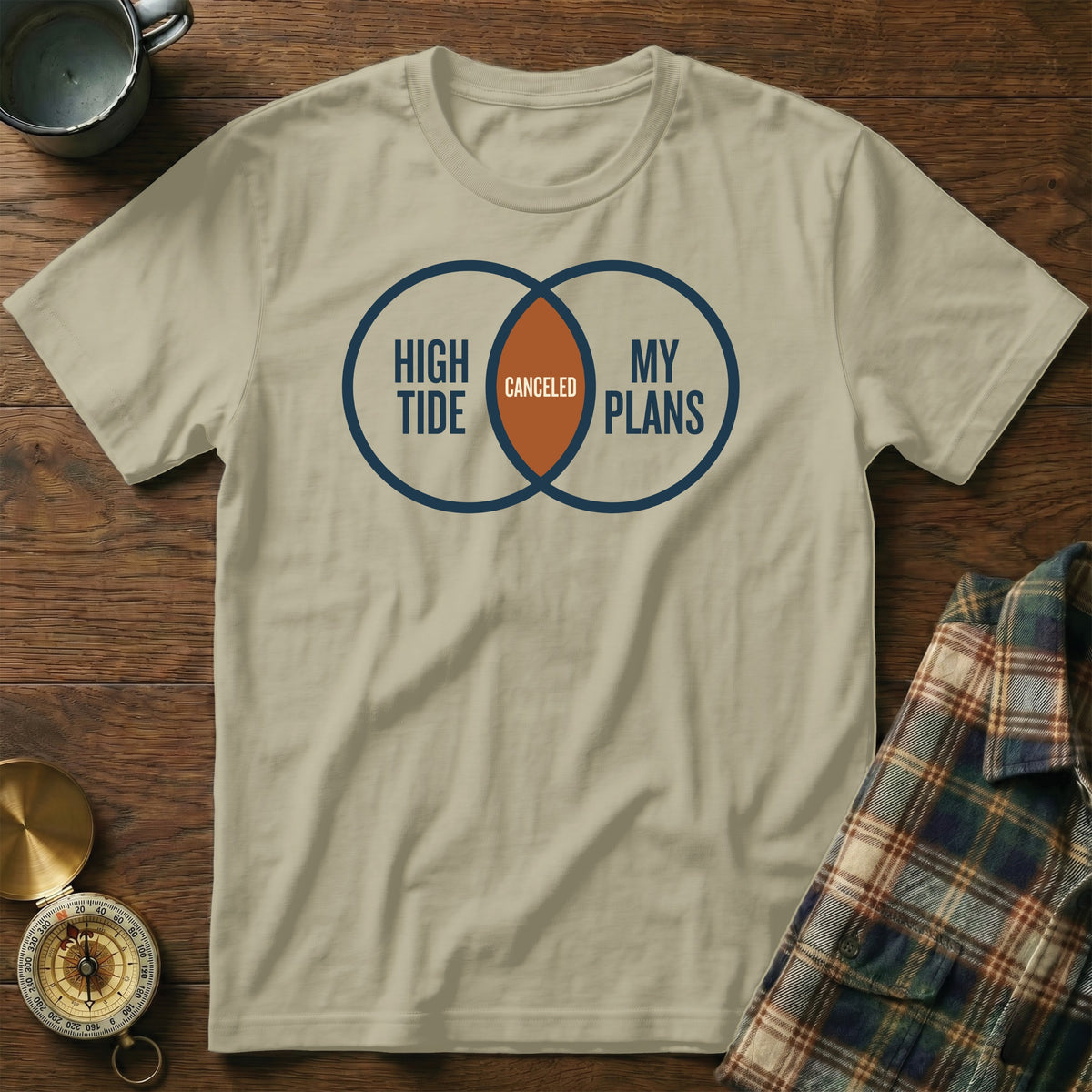 Tan t-shirt with Venn diagram graphic: "HIGH TIDE," "MY PLANS," and "CANCELED."