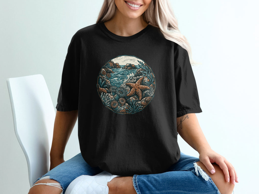 Black t-shirt with circular ocean-themed graphic featuring starfish and coral.