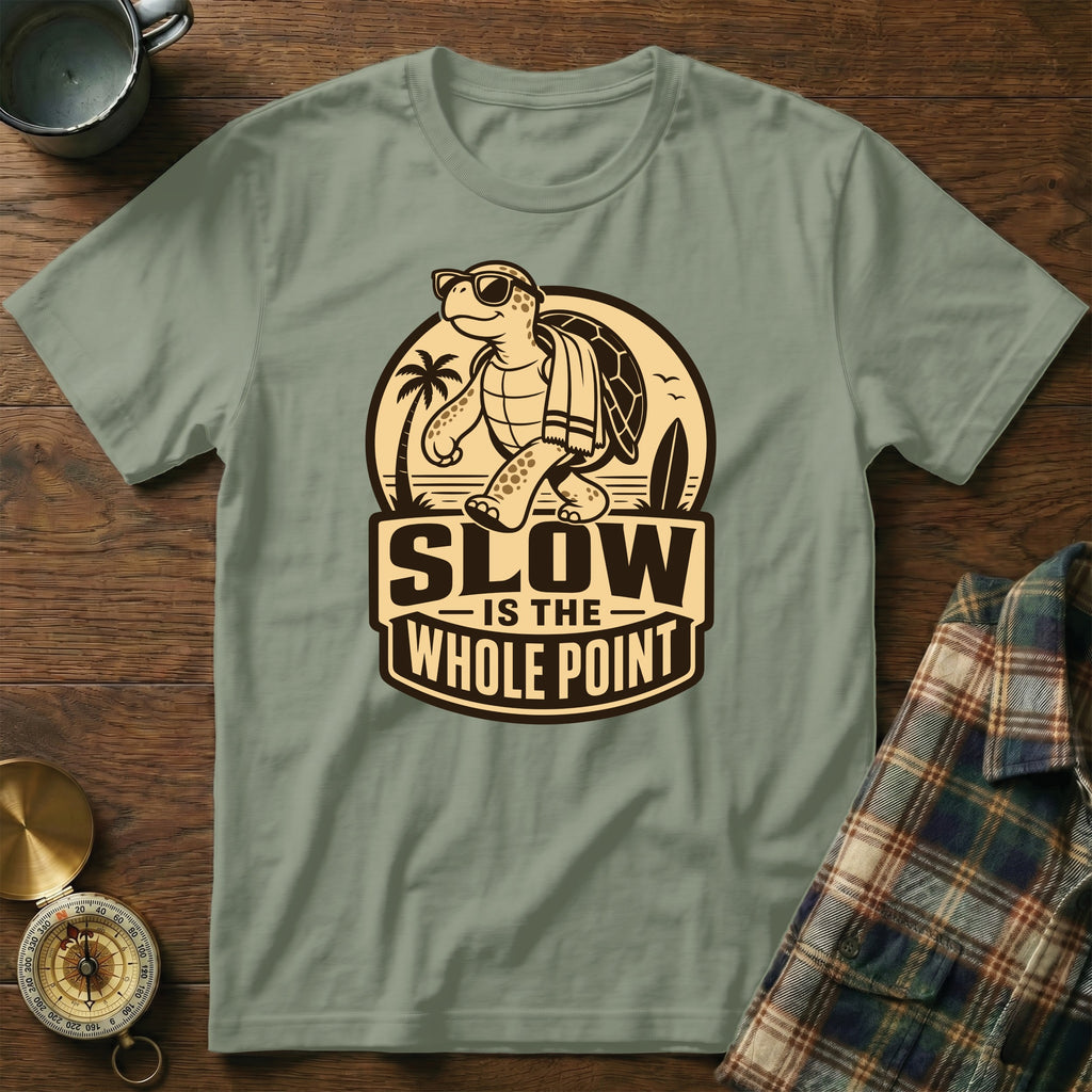 T-shirt with a walking cartoon turtle wearing sunglasses and a towel, text reads "Slow is the Whole Point".