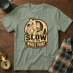 T-shirt with a walking cartoon turtle wearing sunglasses and a towel, text reads "Slow is the Whole Point".