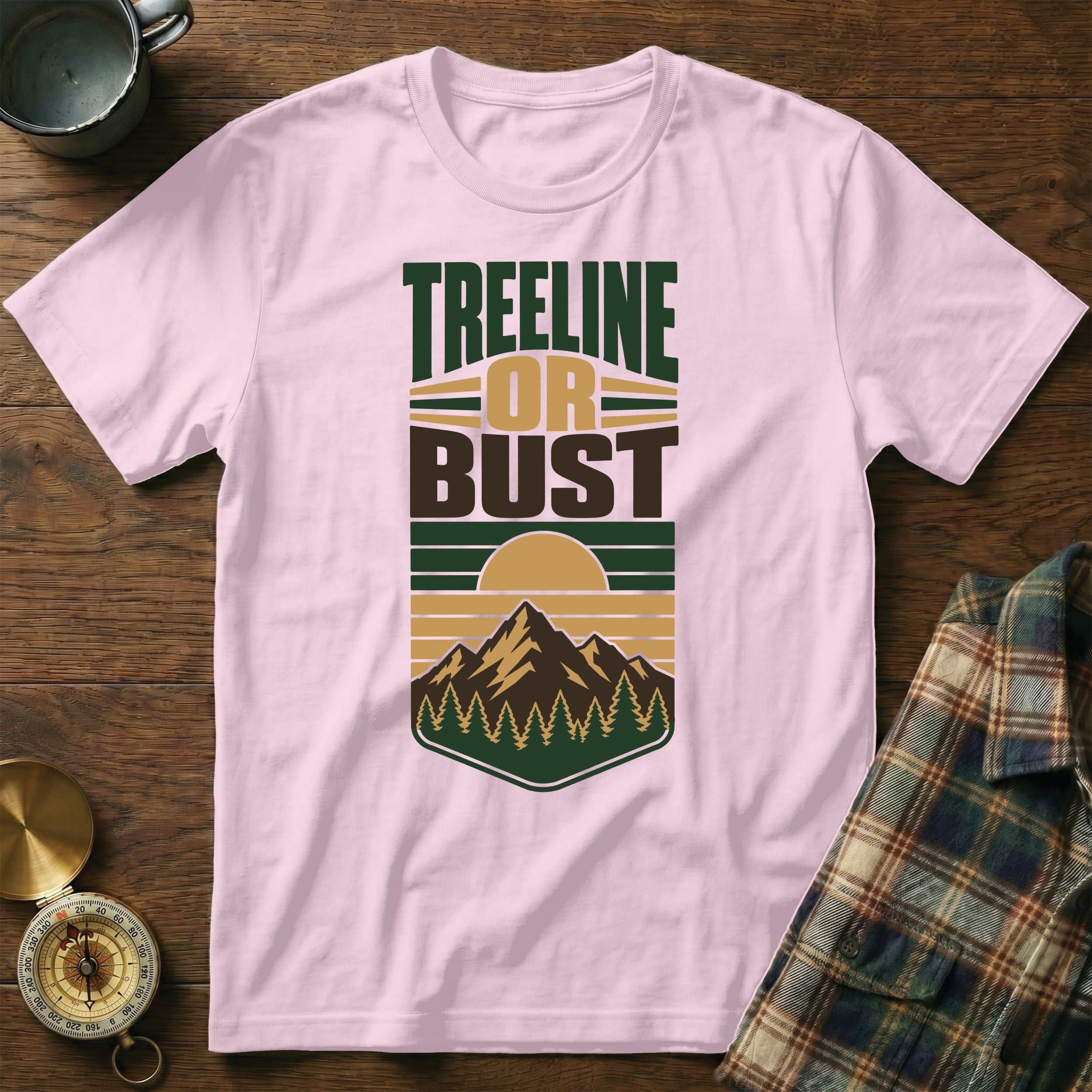 Pink t-shirt with "Treeline or Bust" text and mountain graphic.
