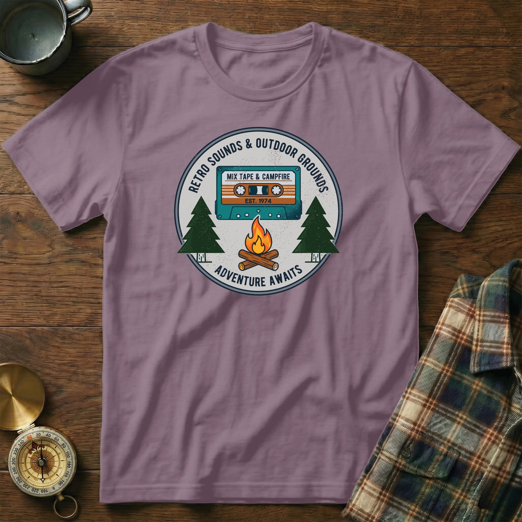 T-shirt graphic with retro cassette, campfire, and "Adventure Awaits" text.