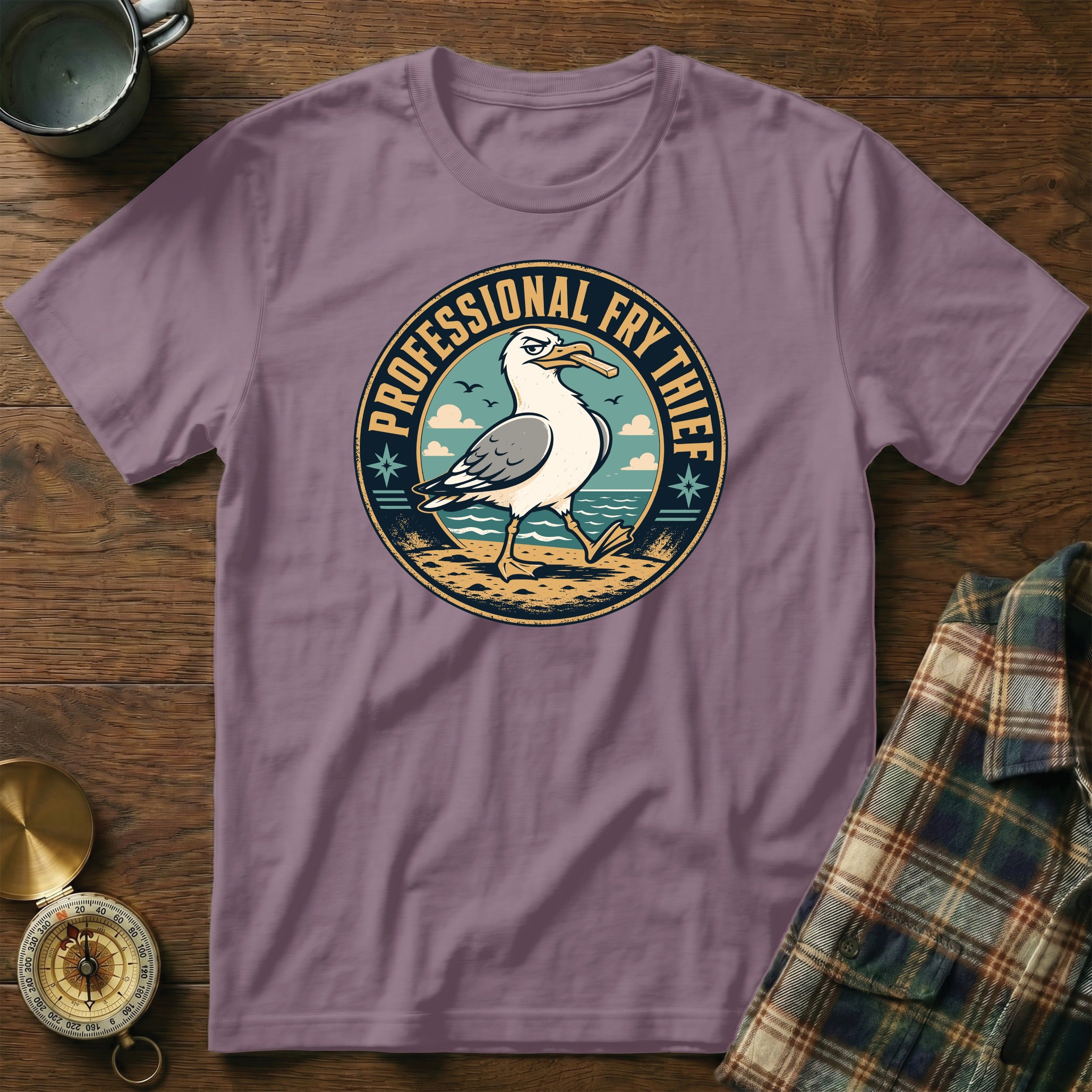 Seagull with fries graphic and "PROFESSIONAL FRY THIEF" text on a purple t-shirt.
