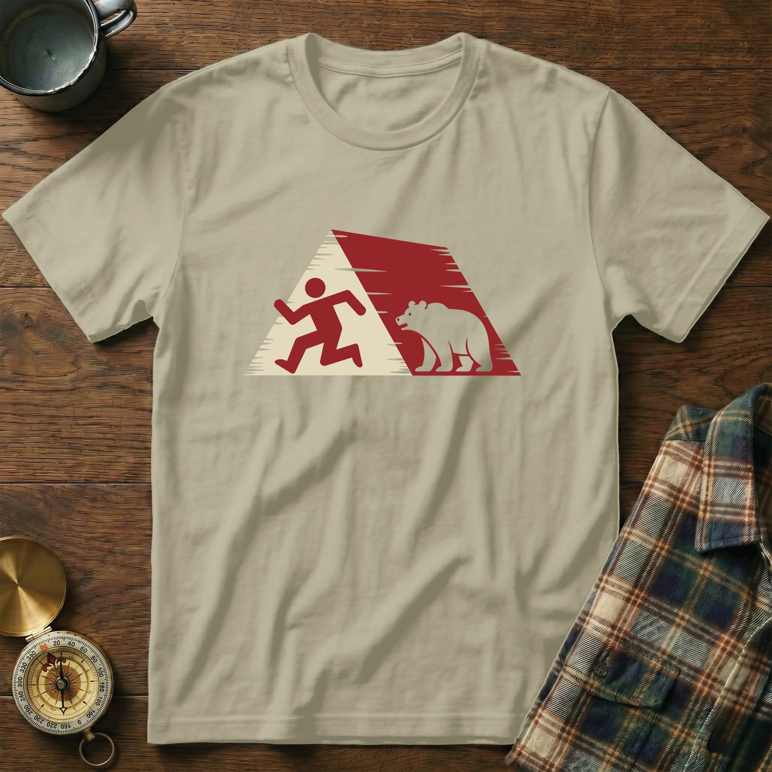 T-shirt with abstract running man and bear graphic on beige background.