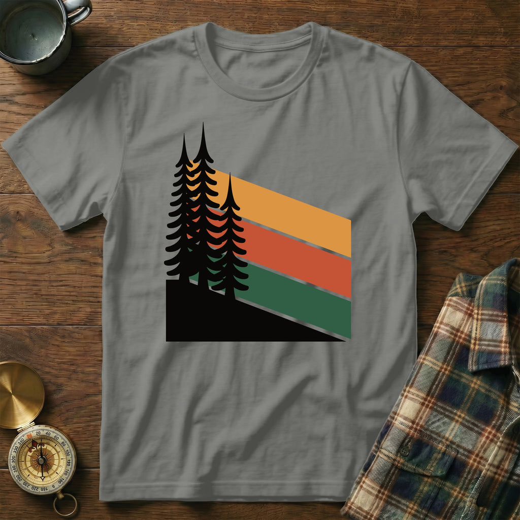Graphic t-shirt featuring stylized pine trees and colorful retro stripes.
