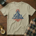 Tan t-shirt with anchor, mountain, sun, and water graphic.