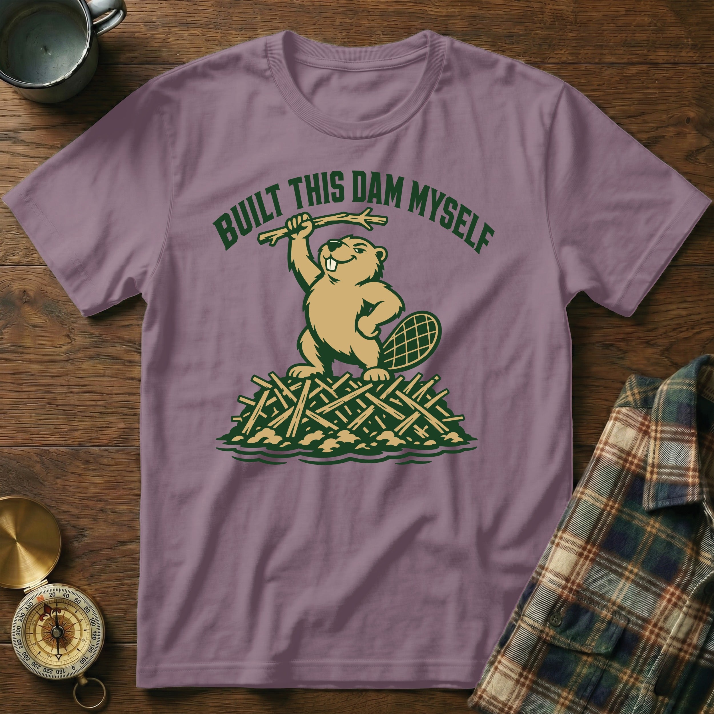 Beaver on a dam, text "Built This Dam Myself" on a purple t-shirt.
